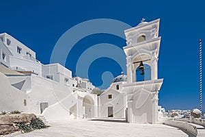 Traditional blue dome church and white bell tower in Santorini in Greece