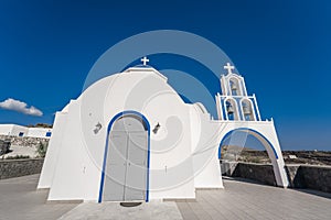 Traditional blue dome church and white bell tower in Santorini in Greece