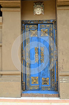 Traditional blue painted front doors of a house in Bali