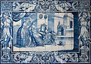 Traditional blue tiles or azulejos decorated with a domestic scene. Lisbon. Portugal