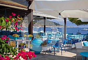 Traditional blue and white greek tavern with magnificent sea view on a summer sunny day in Kastos island, Lefkada