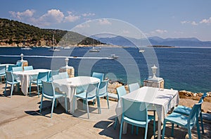 Traditional blue and white greek tavern with magnificent sea view on a summer sunny day in Kastos island, Lefkada