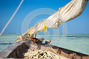 Traditional boat on beautiful beach and tropical sea at low tide in Jambiani, Zanzibar, Tanzania Africa