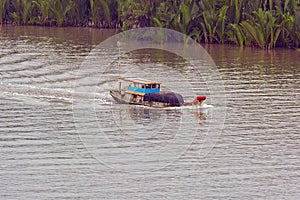 Traditional boat carry freight on the Long Tau river.