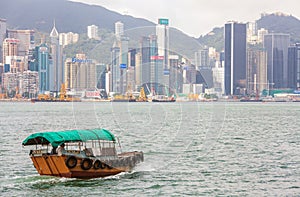 Traditional Boat in front of Hong Kong Harbour Skyline