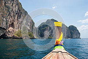 Traditional boat and island of Phi Phi Leh on the horizon,Thail