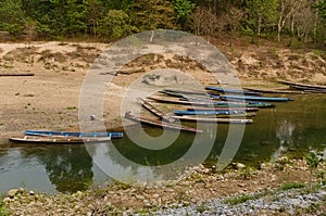 Traditional boats canoe on coastline of Nam Hinboun River Nam Hin Bun in a small village in Laos