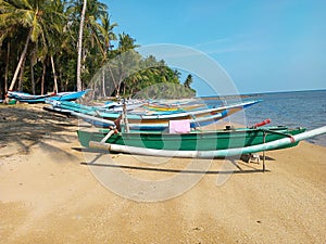 The traditional boats of the people of Bawean Island are parked on the beach photo
