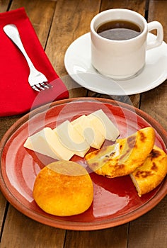 Traditional BoyacÃ¡ breakfast - Arepa, almojabana, cheese and hot aguapanela