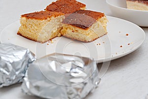 Traditional Brazilian dessert known as Bolo Gelado - Making step by step: Cake pieces wrapped and not wrapped in aluminum foil photo