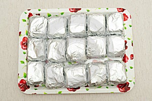 Traditional Brazilian dessert known as BOLO GELADO in Portuguese - Making step by step: cakes wrapped in aluminum foil photo