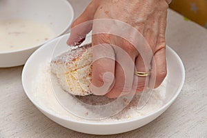 Traditional Brazilian dessert known as BOLO GELADO in Portuguese - Making step by step: Hand picking up piece of cake