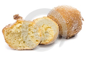 Traditional Brazilian mini fried cake called bolinho de chuva with one open isolated in white background close photo