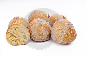 Traditional Brazilian mini fried cakes called bolinho de chuva with one open isolated in white background photo