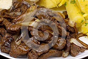 Traditional Brazilian pub food striploin with onions