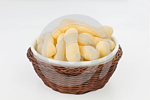 Traditional Brazilian starch biscuit called biscoito de polvilho in a basket isolated in white background photo
