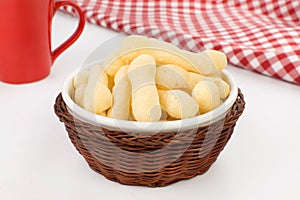 Traditional Brazilian starch biscuit called biscoito de polvilho in a basket in a white background coffe table photo