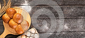 Traditional bread pampushka buns with garlic and herbs on a wooden table, flat lay.