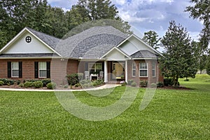 Traditional Brick House on Green Lawn with Mature Trees