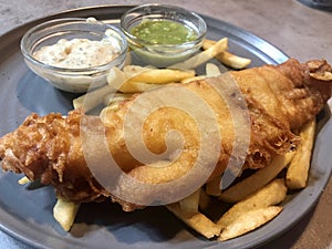 Traditional british cuisine, fish and chips with tartar sauce