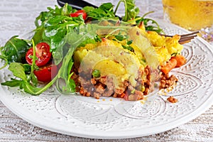 Traditional british shepard pie on plate with salad