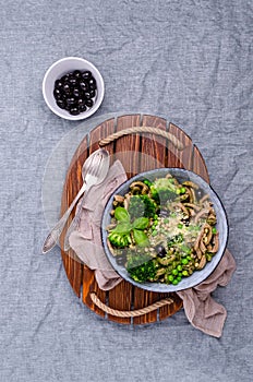 Traditional brown pasta with green vegetables