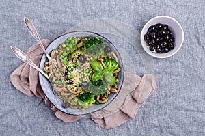 Traditional brown pasta with green vegetables