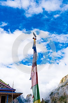 Traditional buddhist prayer flags over blue sky background