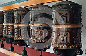 Traditional Buddhist prayer wheels with mantras. photo