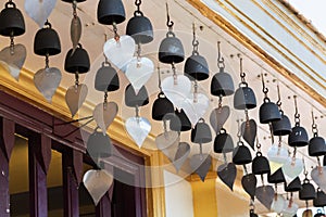 Traditional buddhist wish bells under the roof of a temple in Bangkok, Thailand