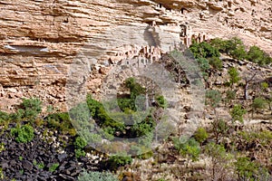 Traditional buildings along a cliff base