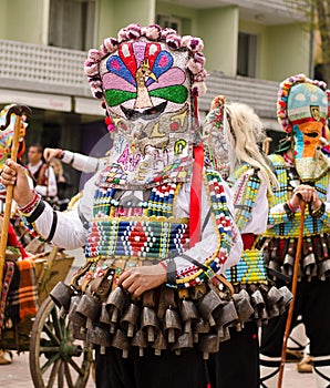 Traditional Bulgarian kuker man with his giant colorful evil mask