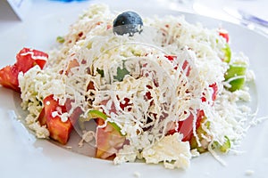 Traditional Bulgarian salad with tomatoes, cucumbers, cheese and olive