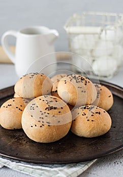 traditional bun with black sesame seeds on a metal tray