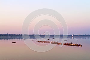 Traditional burmese boats on Taungthaman Lake at sunset, in Amarapura, Mandalay Myanmar