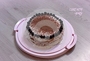 Traditional cake with honey, blackberries and grated dark chocolate