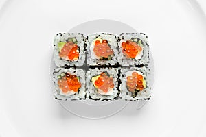 Traditional california sushi roll with red caviar, cucumber on a white background top view