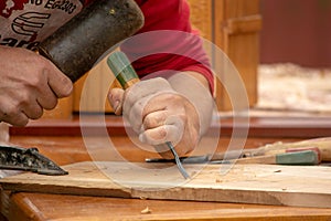 Traditional carpenter close up working hands with carpeting tools.