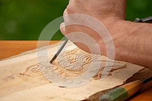 Traditional carpenter close up working hands with carpeting tools.