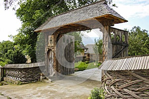 Traditional carved wooden gate in the old vilage Sighetu Marmatiei,Maramures, Romania. photo