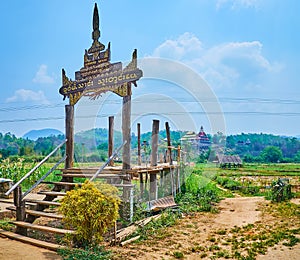 Traditional carved wooden gate of Su Tong Pae bamboo bridge, Mae Hong Son suburb, Thailand