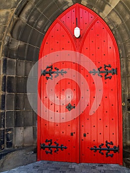 Traditional castle or fortress door closed and painted bright red