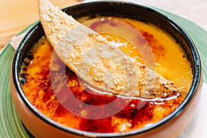 Traditional Catalan cream brulee on ceramic plate. Typical spanish dessert