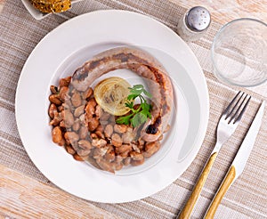 Traditional Catalan dish stewed beans with sausage. Butifarra con alubias photo