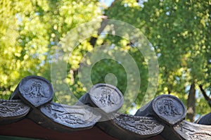 Traditional ceiling dragon tiles of Korean Hanok Village building with old wooden roof in the afternoon in Seoul, South Korea