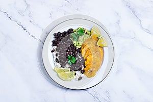 Rice with black beans, fried tostones, plantains, guacamole sauce photo
