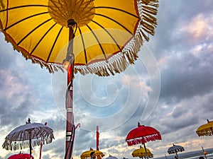 Traditional ceremonial umbrellas and flags on beach at ceremony