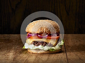 Traditional Cheeseburgers on wooden background.