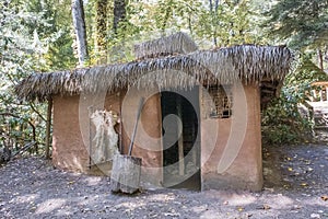 Traditional Cherokee home with thatched roof: Oconaluftee Indian Village, Cherokee, North Carolina, USA photo