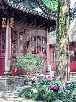 Traditional chinese building with ornate roof and red windows at Yu Gardens, Shanghai, China